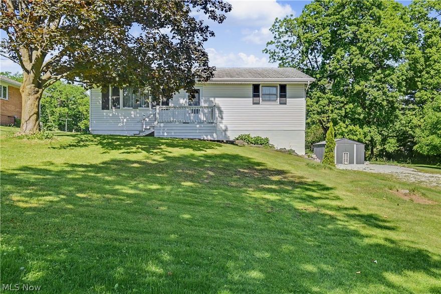 Enjoy the ease of move-in-ready living in this beautifully remodeled ranch set on a spacious lot with scenic views and room to roam. Fresh paint, new flooring, and new carpet create a bright, welcoming atmosphere throughout the home. The large living room offers plenty of space to gather, while the updated kitchen features white cabinetry, subway tile backsplash, stainless steel appliances, abundant counter space, and a dining area perfect for everyday meals. Two comfortable bedrooms and a full bath complete the main level. Downstairs, you'll find a second full bathroom and a versatile lower level with endless possibilities for a family room, recreation area, home office, or workout space. Step outside to enjoy the expansive backyard, mature trees, storage shed, and peaceful setting with beautiful views in every season. A wonderful opportunity to own an updated home that combines comfort, functionality, and outdoor space in one attractive package.