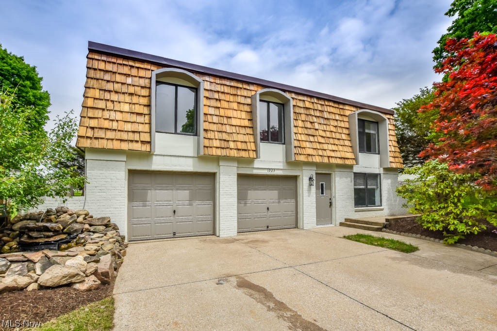 This beautifully updated bi-level home in Orrville is the perfect blend of modern and rustic charm. The cedar shake mansard style roof boasts unique curb appeal that sets it apart from others in the neighborhood, while the interior features a warm and inviting atmosphere. The main level offers a spacious family room with a gas fireplace, new carpeting, wood beam accents, and a sliding door that opens to a patio. This level also includes a half bath, laundry area, and access to the 2 car garage. Upstairs, you'll love the open concept with new luxury vinyl plank flooring. A wood beam frames the opening to the gorgeous new kitchen complete with a center island with counter seating, granite countertops, subway tile backsplash, and stainless steel appliances. Enjoy outdoor entertaining or relaxing on the deck overlooking the tree-lined backyard with a shed for storage. Down the hall are all 3 bedrooms including the master with a convenient half bath. The main full bath has been remodeled wi
