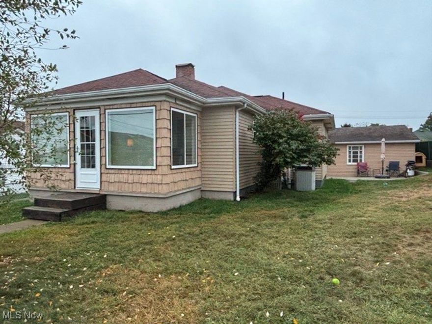 Charming and well-maintained 2-bedroom ranch situated on a fully fenced corner lot with a 2-car detached garage. This inviting home features a fully equipped kitchen and dining room with built-in shelving, a comfortable living room that opens to an enclosed front porch—perfect for morning coffee or afternoon relaxation—plus 2 bedrooms, 1 full bath, and a versatile bonus room ideal for a home office or den.  The full basement offers a workshop, laundry area, and abundant storage space. Recent updates include newer luxury vinyl flooring throughout. Conveniently located near Rt. 22, the PA/OH borders, and all local amenities.  This home is move-in ready.