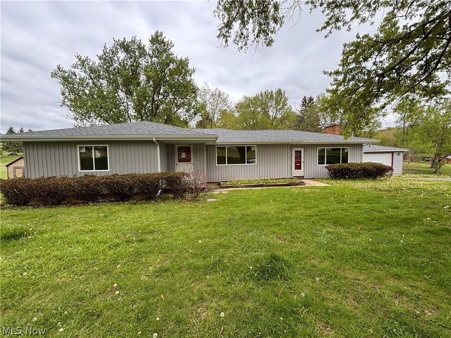 2–3 bedroom ranch situated on a .73-acre country lot, offering a great opportunity to add your personal touch while benefiting from extensive recent upgrades (2025–2026). Major improvements include connection to public sewer, new windows, new roof, soffit, fascia, gutters and downspouts, two new sump pumps, new hot water tank, and updated exterior electric with disconnect.
The home is ready for your finishing touches—bring your remodeling ideas and make it your own. The previous owner removed a wall between two bedrooms, creating flexible space that can easily be converted back to a third bedroom if desired.
The spacious main-level family room features a beautiful stone fireplace and provides access to a covered patio and fenced backyard—perfect for outdoor enjoyment. A detached two-car garage with a new roof adds additional convenience.
The expansive 1,800+ sq. ft. basement offers abundant storage and excellent potential for additional finished living space.