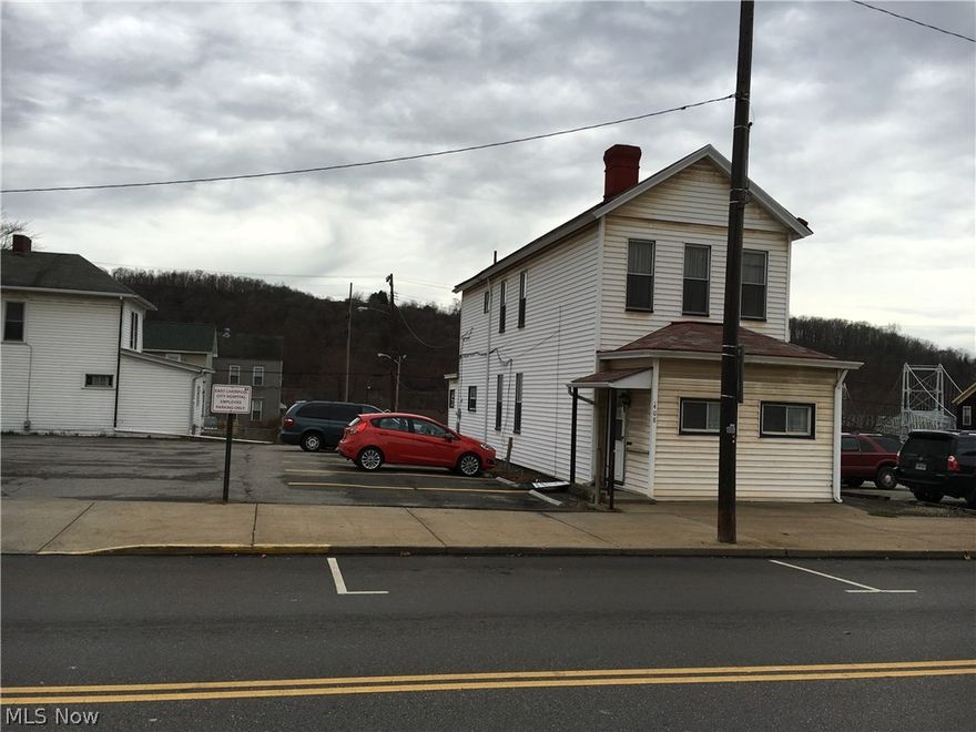 REDUCED!! Two story home that sits alone between two parking lots near City Hospital.  Home needs a little TLC.  Nice large rooms, with a full bath on main floor and second floor.  Home has central air.