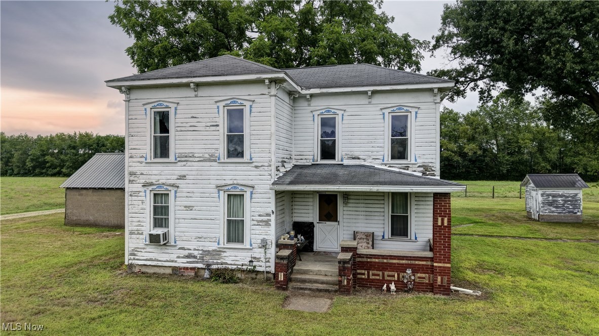 Auction begins closing Monday, September 29th at 6:00 PM. Step back in time with this charming turn-of-the-century farmstead, offering 6.15 acres of open, level ground in a desirable location and school district. Tucked back from the road, the farmhouse provides 1,536 sq. ft. of living space, including 3 bedrooms, 1 full bath, a kitchen, dining room, and living room. The home features wood siding, a shingle roof, a welcoming front porch, and a back stoop. The yard has a very large walnut and oak tree along with apple trees and a grape vine. The property includes four outbuildings: a 40’x50’ flat barn, a 36’x38’ flat barn, a 36’x36’ framed shed, and a 20’x25’ detached garage—perfect for storage, livestock, or hobby use. A Coshocton City water tap is available at the road. This is a unique opportunity to own a country property with old-time charm and modern potential in a sought-after area.
