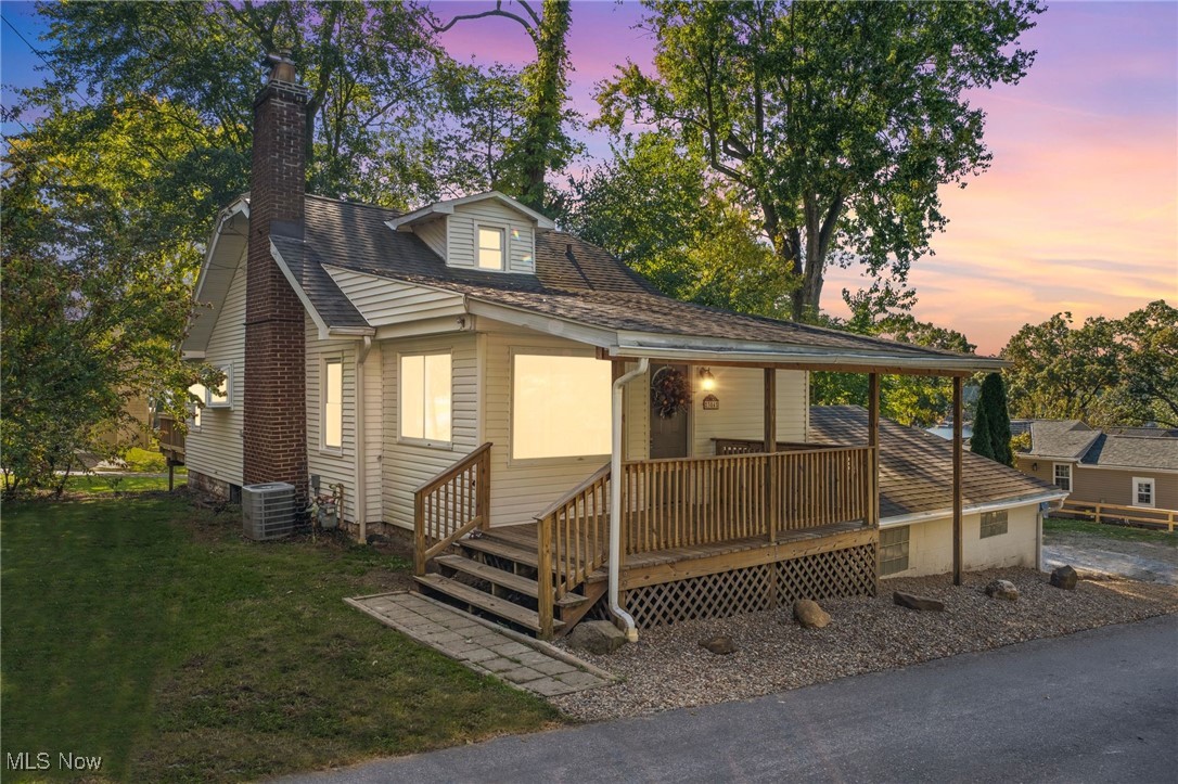 Charm abounds in this renovated Cape Cod in Portage Lakes!This adorable home checks the list for both owner occupants & investors! Enter the home from the covered front porch-a perfect spot for morning coffee with peeks of the lake near by. The sitting room greets you with large windows & beautiful natural light-just the right place to greet guests &/or sit and read a book.From the moment you step inside you are introduced to an open floor plan that flows from the sitting room to the family-to the eat in kitchen - right to the deck and wooded back yard!!! WOW! The main living space has high ceilings highlighted by an original masonry wood burning fireplace. Entertaining guests would be fabulous in this space-enjoy a crackling fire while preparing & serving friends & family in this incredible space! The first floor offers a large Owners Bedroom with an attached full bath. A 2nd bedroom with both a closet & built in storage round out the first floor. Upstairs you'll find a bonus room/optional 3rd large bedroom -with walk in closet area, peeks of the lake & loads of charm! Head down to the lower level-with a laundry room, half bath, utility room,& flex room.This flex space can easily be used as an office, play room, gym or craft room-the possibilities are endless! But wait-there's more!! From the laundry room-head outside to a completely COVERED and SCREENED IN walk out porch! Rain or shine you can use this space! Wine tasting/summer movie nights/cocoa on a snowy day/or a workshop area-bring your ideas & creativity to this space-what a BONUS! With an attached garage, separate storage for your jet skis kayaks & more + parking for up to 8 vehicles - what are you waiting for? Located in the heart of Portage Lakes just off the West Reservoir. Your opportunity for a vacation home w/year round lake life: swim/boat/fish/hunt/hike - something for every season!Dine at Lala's/Nauti Vine/Upper Deck Just 45 mins from Cleveland/Minutes to PLX State Park & Nimisila Res. CALL TODAY