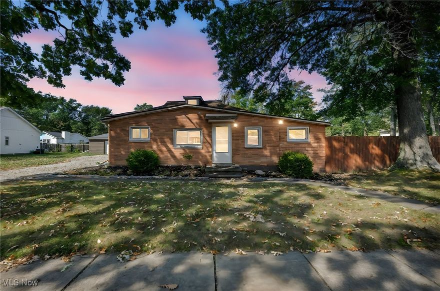Welcome to 808 Robinwood Avenue, a thoughtfully updated single-story ranch in the heart of Sheffield Lake. This charming 2-bedroom, 1-bath home offers approximately 1,330 square feet of living space and sits on a generous .33-acre corner lot at the end of a quiet dead-end street, providing privacy, space, and a peaceful suburban setting. Built in 1940 and carefully remodeled, this home blends timeless character with modern upgrades. Step inside and you are greeted by a spacious open floorplan featuring vaulted and beamed ceilings, recessed lighting, and abundant natural light. The large living room (17x21) offers stylish LVT flooring and plenty of space to relax or entertain. The eat-in kitchen is highlighted by granite countertops, ceramic tile flooring, custom finishes, and vaulted ceilings, making it a wonderful gathering place. The private master bedroom features a walk-in closet and direct access to the updated bath with a soaking tub and double vanity. A second bedroom provides flexibility, while a separate office offers the perfect space for working from home. The spacious main-level laundry room includes a sink, hookups, and extra storage for convenience. Outdoors, enjoy a covered patio, a large deck, a fenced backyard, fire pit, and mature landscaping—perfect for entertaining or quiet evenings. A detached 2-car garage with opener and extra driveway space provides ample parking and storage. Updates include energy-efficient windows, newer roof, HVAC, appliances, and lighting. The property’s location in the Border Cities subdivision offers nearby parks, sidewalks, playgrounds, and Lake Erie access. Close to schools, dining, shopping, and major highways, this move-in-ready home combines modern comfort with small-town charm. Whether you are a first-time buyer, downsizing, or simply looking for a well-maintained ranch with character, 808 Robinwood Avenue is a wonderful opportunity to own a beautifully updated home in a desirable area. Schedule your showing today!