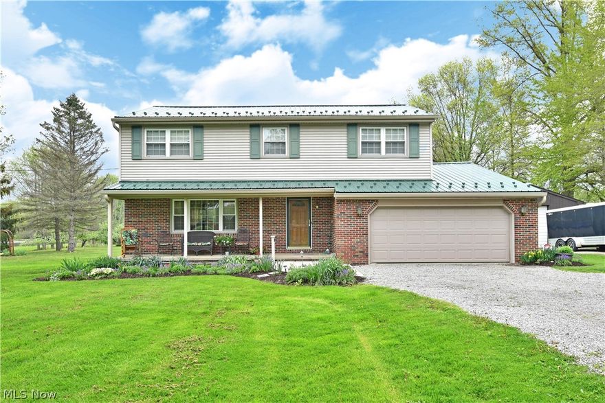Take in the scenic views and the expansive, four-bedroom layout of this beautiful Cortland home! A pair of winding driveways meet to create a flattering turn-around as perfectly kept landscaping fills in between the tall trees that lead up to the home. The robust steel roof showcases its bold green color as the lower brick façade adds to the curb appeal. The real treat is around back however as a breathtaking rear deck area stuns with its pergola seating and tiered outdoor space, all neatly accented with flush foliage. A large outbuilding joins the attached two car garage to complete the package. Inside, a relaxing living room awaits with carpeted flooring while the main staircase rises away from the hardwood styled foyer floors. The rear central kitchen delights with casual, eat-in dining space as wrapping countertops pair with the custom wood cabinetry. Formal dining can be found adjacently. A half bath sits opposite before family room access where a brick fireplace sits center. Upstairs, four inviting bedrooms include an oversized master suite with walk in closet and full private bath. A second full bath brings bold colors and a substantial vanity at mid hall. The remaining bedrooms share the bright colorways and carpeted flooring. At the basement level, painted and sealed storage is combined with rec space.
