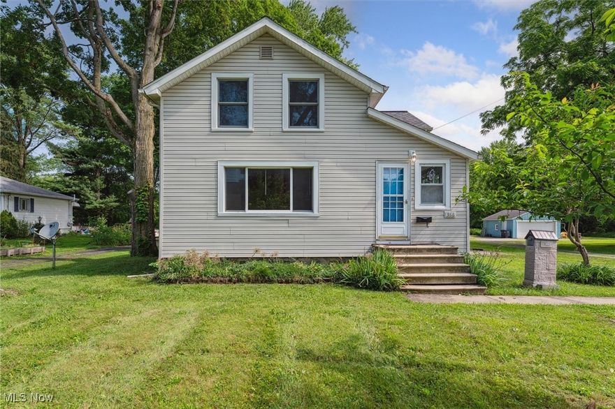 Conveniently located within walking distance from Oberlin College and the vibrant Oberlin downtown, this simple, charming home has been recently updated with fresh paint and finishes, and is located on 1.5+ acres, on a partially wooded deep lot with two outbuildings. It's curb-lawn has one of the best American Elms in the City, while a large evergreen hedge shields the house from the street. The home itself features a large living room, an eat-in-kitchen, a first-floor primary bedroom with an adjacent full bath, and three small bedrooms upstairs that share a half bath. The spacious living room in the rear has plenty of natural light and ventilation with transoms on the western wall and a band of windows that overlook the rear yard and woods beyond. Just steps down from the kitchen, it has a wood-burning fireplace, and is perfect for hosting gatherings for friends and family. Downstairs, the unfinished basement houses the laundry, a workshop room with built-in shelves, and plenty of storage space. Newer roof with leaf-guard gutters! Outside, a 14x10 gazebo with electricity is perfect for outdoor reading, relaxing, or gatherings. An adjacent 25x12 outbuilding offers ample additional storage or could be reimagined as a creative studio, workshop, or garden shed. Both structures are in need of a little TLC, but their potential is undeniable! The wooded rear parcel also offers a quiet backdrop for added privacy and a peaceful touch of nature. The home itself is move-in ready – schedule your tour today!