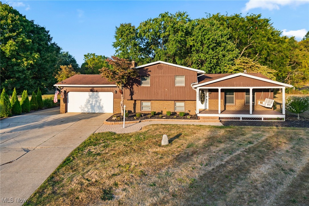Set on nearly an acre this updated home pairs modern touches with inviting spaces. Fresh flooring runs throughout the main living areas, and both bathrooms have been tastefully refreshed. A generous rec room with a cozy fireplace makes an ideal gathering spot, while the enclosed rear porch flows to a large deck, concrete patio, and partially fenced yard — great for entertaining or relaxing. The oversized 32×24 detached garage offers a second floor with storage and a partially finished bonus room, perfect for hobbies or a studio. A newer roof adds peace of mind, and with Lake Local Schools nearby, this move-in-ready property offers plenty of room to spread out and enjoy.