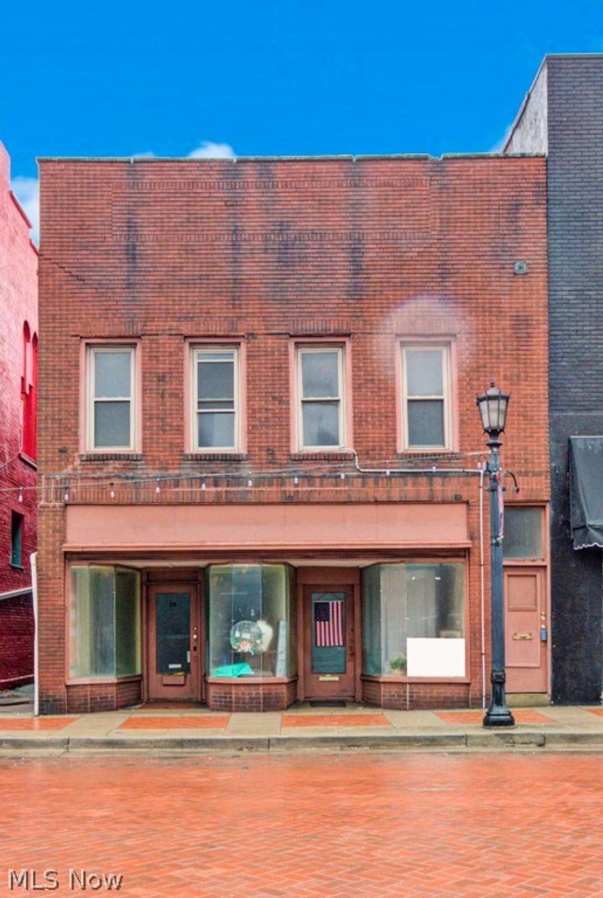 Presenting a prime investment opportunity in the heart of downtown Minerva, this versatile mixed-use building offers both commercial and residential spaces, ideal for entrepreneurs and investors seeking a dynamic property with multiple income streams. Commercial Spaces 210 N Market Street: This expansive storefront features an open layout complemented by a convenient half bathroom, providing a blank canvas for various business ventures. 212 N Market Street: Equipped with a full bathroom. Its rear access via the alley enhances convenience for deliveries or private entry.  Residential Units: Front Apartment: Overlooking the vibrant downtown area, this one-bedroom apartment boasts hardwood floors, an updated full bathroom, and a closet with built-in storage and a dedicated hot water heater. Electric heating ensures comfort throughout the seasons.  Rear Apartment: This spacious unit includes two bedrooms, a full bathroom, two distinct living areas, and a well-appointed kitchen. A gas furnace provides efficient heating, catering to the needs of potential tenants. The flat roof underwent resealing in 2023, ensuring durability and reducing future maintenance concerns.
This property stands as a testament to downtown's architectural charm, offering a unique blend of commercial and residential spaces.