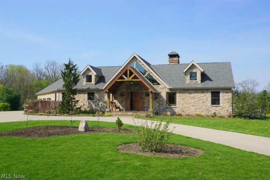 Escape to your own private retreat on 5.7 acres in Lake Township!  This custom Craftsman style home is a work of art with exceptional quality & attention to detail. Pre-distressed hickory hardwood floors, knotty alder cabinetry & trim, custom wrought iron, & hand-hewn beams adorn this 3,800 sqft, 3 bedroom, 2.5 bath ranch. Expansive windows allow light to flood the home & the views are spectacular!  Large vaulted Great room with stone
 fireplace leads to dining room & gourmet kitchen with granite & upscale appliances. First floor master suite offers fireplace, beautiful bath with steam shower & two huge walk-in closets. A staircase built with reclaimed barn beams leads to the  walk-out finished lower level where you'll find a family room with stone fireplace, large recreation room, wine barrel bar, 2 bedrooms & full bath. The outdoor space includes screened porch, huge tropical wood deck, and saltwater in-ground pool. Over-sized laundry/mudroom leads to 3 car heated garage. 40x24 insulated barn with greenhouse features windows from Glamorgan Castle in Alliance. Surround it all with exceptional landscaping and you have the perfect setting!