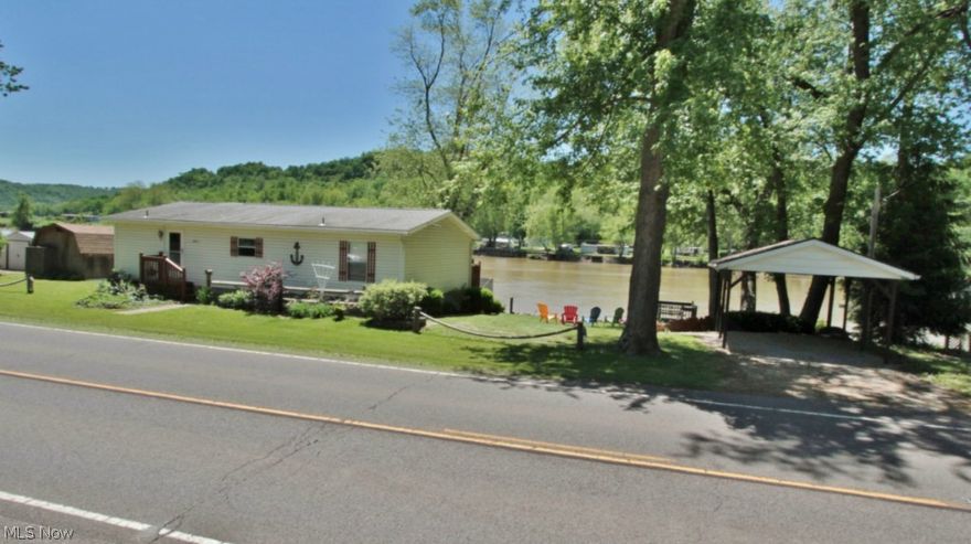 What a place to relax, or call home.  River front home with 3 bedrooms and two full baths.  Eat in kitchen.  Large deck on River side of home, small picnic deck overlooking water.  Fire pit, Large carport beside home.  Shed for storage.   Steel steps to river for dock.  2+ car detached garage, great for parking, boat storage or party house.  Plenty of room for campers.   Boat can be purchased for additional money.  Home can be purchased furnished.