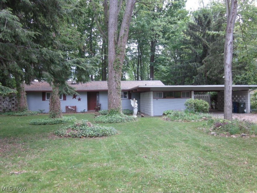 North Ridgeville's best buy!!  A custom 1729 sq ft ranch, at a bargain price of less than $64 per sq ft, on a parklike two-third's of an acre lot!  Stylish one-floor living, with the flair of a Frank Lloyd Wright design, this custom ranch home boasts a wonderful great room, with vaulted ceiling, & floor to ceiling windows, allowing lots of light & gorgeous views of the park-like rear yard.  The impressive brick fireplace offers a fabulous focal point & cozy gathering spot for entertaining & everyday living.  The unique layout spills the living room, dining area, entry foyer, kitchen & den into a very spacious, versatile open-concept floor-plan.  Loaded with innovative built-ins, skylights, & lots of storage throughout, this home features a guest room with built-in Murphy bed as well as a lovely master suite with private patio area.  The den has a movable partition that can be closed to use the den as a third bedroom, if needed, & the oversized laundry/ hobby room has plenty of possibil