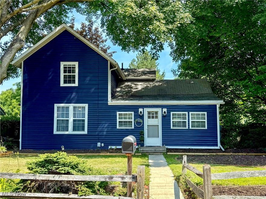 Nestled on a tree-lined street, this vibrant blue gem offers great curb appeal and a warm welcome. With three bedrooms and two full baths spread across two stories, this home is ideal for anyone seeking extra living space combined with character, comfort and convenience. The main level features a charming living room with a bay window with a seat, as well as a beautifully updated kitchen equipped with all appliances, ensuring effortless meal preparation. A cute dining nook is the perfect spot for enjoying your culinary creations. The convenience of a first-floor primary bedroom, complete with an office/den and a full bath, makes this home not only functional but incredibly inviting. New flooring runs throughout the main level for a fresh, cohesive look. The second floor offers two additional bedrooms and a full bath, providing ample room for loved ones and guests. You'll enjoy generous closet space in the bedrooms and extra storage tucked throughout the house, plus central air to keep you cool in the summer heat. A full unfinished basement includes a beautiful fireplace, a laundry area with washer and dryer, and a walk-out to the backyard. Speaking of the backyard, it's verdant, private and partially fenced with plenty of room to run. There is also a storage shed, a one-car garage and a gravel driveway for extra parking. This residence is located just a short drive from several top universities, making it an ideal choice for students, faculty and professionals alike. As a bonus, the seller is throwing in a one-year home warranty for the lucky buyer. Don't miss the opportunity to make this wonderful house your own!