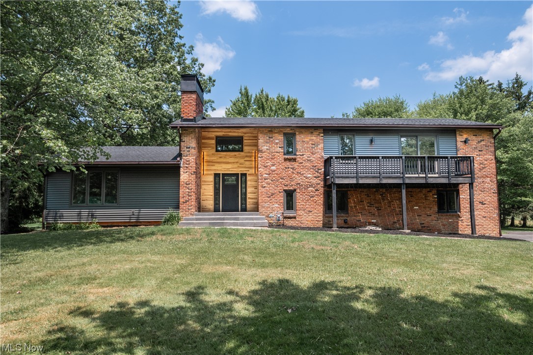 Welcome to this completely renovated home in Chesterland, OH. Offering 5 Bedrooms & 2.5 Bathrooms on approx. 2.7 Acres. Paved Driveway lined in stone winds you around to a 3-car garage with plenty of acres for additional outbuildings. Rear deck allows you to enjoy the shaded back yard where you can add a pool & firepit for hot summer days. Huge Mud Room on the ground level allows access to the garage, backyard, Laundry, & half Bath. Making it easily accessible for entertaining. Main Level has a modern eat-in kitchen with gray quartz countertops, backsplash, new appliances including air-fry gas stove, hood, & 4 Seating Cutout Bar. Living Room has a cozy wood fireplace with an adjacent formal dining room. Hardy Brazilian Walnut hardwood flooring throughout the level. Upstairs 5 bedroom including an Owner’s Suite with balconies. Owner's bathroom includes dual headed Shower with tile surroundings & gold accepts on glass doors & fixtures. The finished basement features a bar area, a gas fir