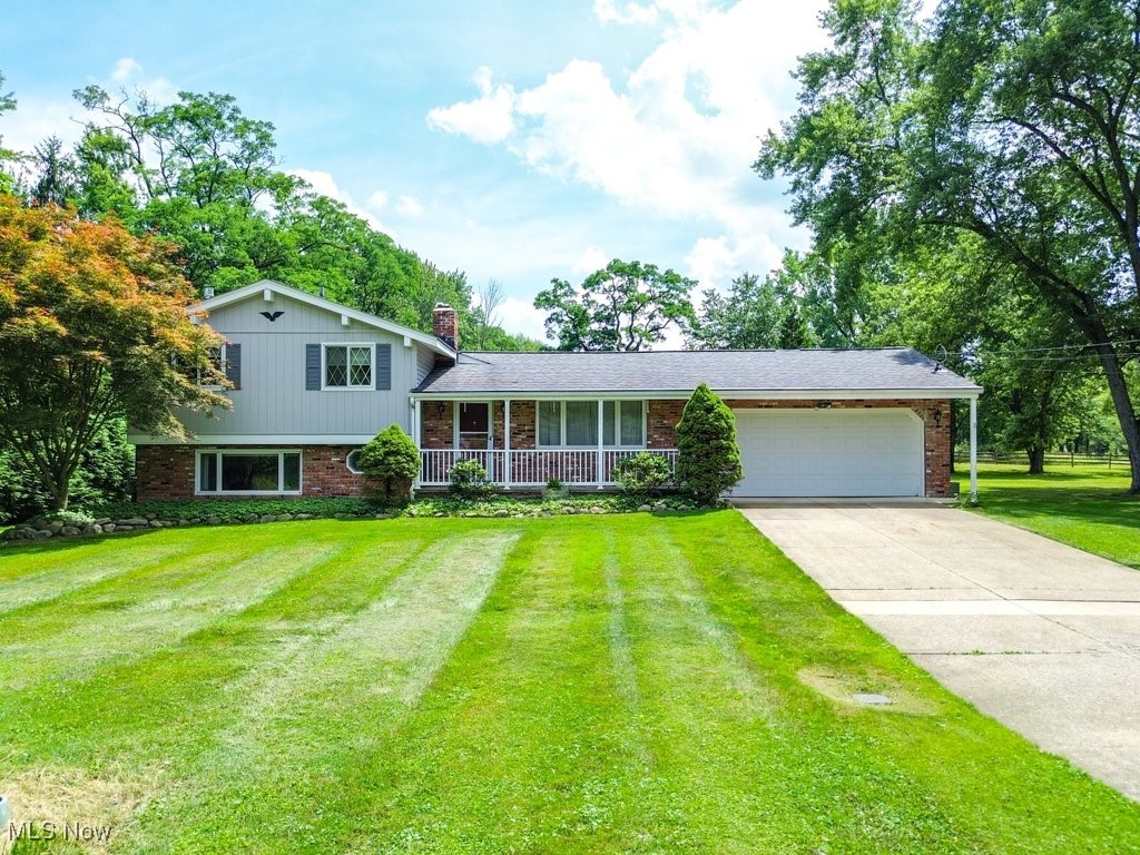 Rare North Royalton Gem on Over 2 Acres! Discover the perfect blend of space, style, and serenity in this beautifully maintained 3-bedroom, 2.5-bath split-level home with an attached 2-car garage—situated on a private and picturesque 2.34-acre lot. Inside, you'll find charming mid-century modern touches, wood floors throughout, and newer mechanicals. The spacious kitchen features custom-crafted wooden cabinets and overlooks a bright breakfast nook with peaceful views of the backyard—perfect for enjoying your morning coffee. Additional upgrades include a remote-controlled gas fireplace, a whole-house generator, and a cozy four-seasons room. Step outside to unwind on the cobblestone patio, or enjoy the lower-level walk-out patio ideal for entertaining. The property features a barn, fenced areas, and even a worm farm—ideal for gardening enthusiasts or those craving country living with modern convenience. This one-of-a-kind property offers the best of both worlds: peaceful acreage and a prime North Royalton location. Move-in ready and truly well cared for—opportunities like this don’t come often!