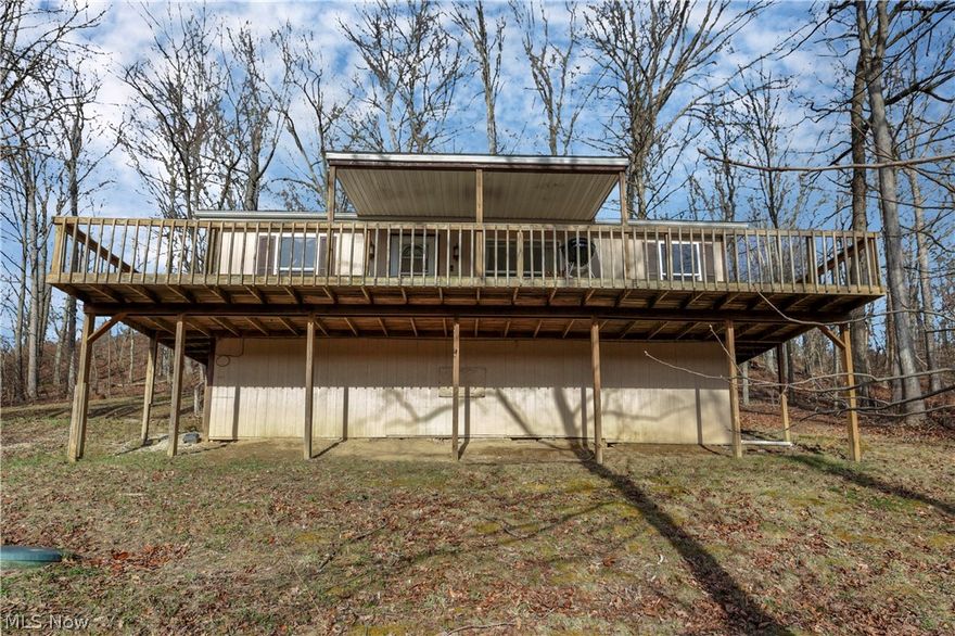 Discover true serenity on this unique 2.28 acre estate. Perfectly positioned for those seeking peace and privacy.  This home offers the ultimate retreat from the hustle and bustle without sacrificing convenience. You are just minutes away from Salt Fork State Park, local shopping, I-77, and charming downtown Cambridge. This property is a dream come true for hunting enthusiasts and nature lovers alike. Experience the changing seasons from the expansive wrap-around deck or find your center on the front porch, the premier point for golden sunsets. As night falls, the private backyard fire pit offers an intimate setting for gatherings under the stars. The home offers a functional split-floor plan for maximum privacy, featuring a master suite on one end and two guest rooms on the other. Whether you are looking for a full-time residence, a weekend retreat, or a premier hunting basecamp, this home is designed for those who appreciate the tranquility of nature. With its proximity to Salt Fork State Park and I-77, this unique estate is a prime candidate for a lucrative short-term rental. All appliances stay and the home is offered fully furnished. This is a unique property that must be seen to be fully appreciated.