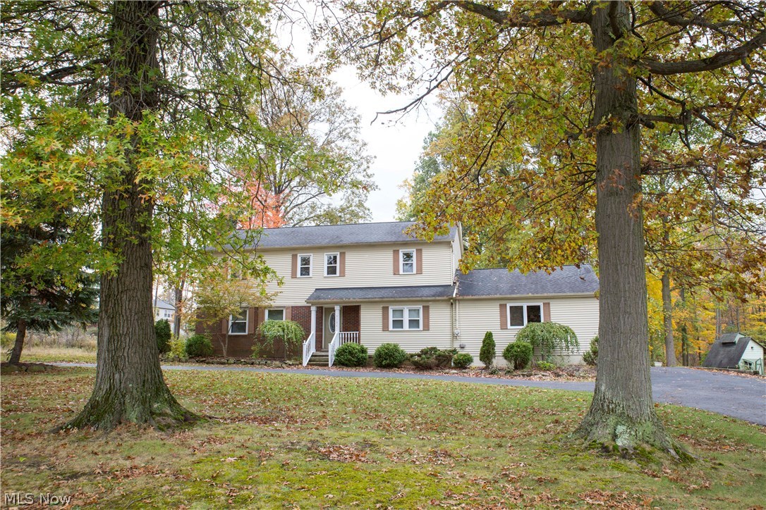 Situated on over 2 wooded acres, this thoughtfully updated colonial in Twinsburg offers plenty of privacy while still being close to everything! Highlights include an updated kitchen with new stainless steel appliances, new carpet and paint throughout, updated lighting, radiant heating for comfortable winters, roof replaced in 2006, and neutral décor for any style. You’ll love the bright and spacious layout featuring 4 large bedrooms, including the master bedroom with its own full bath, and an additional full bath on the second floor. The main floor offers a living room with a fireplace, dining room, office/den, and a family room with large sliding glass doors that lead to the back deck and beautiful wooded and private back yard beyond. The lower level offers an additional living space, rec. area, and plenty of room for storage, laundry, and utilities. The basement also has convenient dual access from the garage and interior of the house. All of this in a great location with easy acces