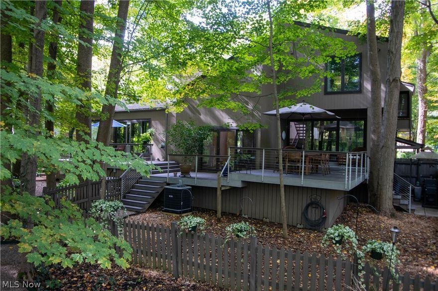 This is the perfect home abutting a Private Lake & Recreation area! Secluded feel, yet 12 minutes to shopping & restaurants! Outdoor living of 723 square feet w/ 3 levels of composite decking +grilling area, views are gorgeous thru huge Pella Sliders surrounding the 1st floor. Home has everything you could possibly want from privacy to the Private Lake & Recreation area: baseball field, volleyball, bocci ball, basketball, to hiking trails, a cabin in the woods feel to finished walk out basement & large home office space. Updated (2019-20) in-law Suite: full kitchen, living rm, full bath & entrance from the home as well as outside w/ ramp for added privacy or use as 1st Floor Master Suite or Entertaining! Gorgeous new carpet & Brazilian cherry hardwood floors just refinished. Both kitchens have been completely updated w/ many true chef's dream features! Main kitchen: stainless steel countertops & appliances: wine fridge, refrig, dishwasher, 2 undercounter convection ovens, bar sink, com