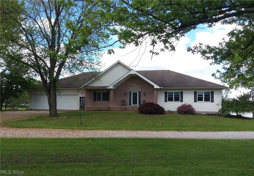 This home offers 4 -5 bedrooms and 4.5 baths on just over 8 acres.  Quality hardwood floors on the main level and oak cabinets and wood work throughout the house, give a warm family feel with classic charm.  The living room and chef's kitchen with dining area access to the 2nd story deck with newly replace railings. There is a first floor In-law suite with private entrance and porch that overlooks the park like back yard and lake. The suite has a full size living room, kitchen, eating area, bedroom and full bath with plenty of on-suite storage. The lower level is finished with a kitchenette, huge recreation room and entertainment area, as well as a large bonus room can be used for a play room, personal gym, or extra bedroom.  The oversized office has a private entrance and could be another in-law suite with a full bath.  The extra large utility/storage room has one of the two furnaces and hot water tanks that service the house. The lower level walks out to a covered patio with a hot tu