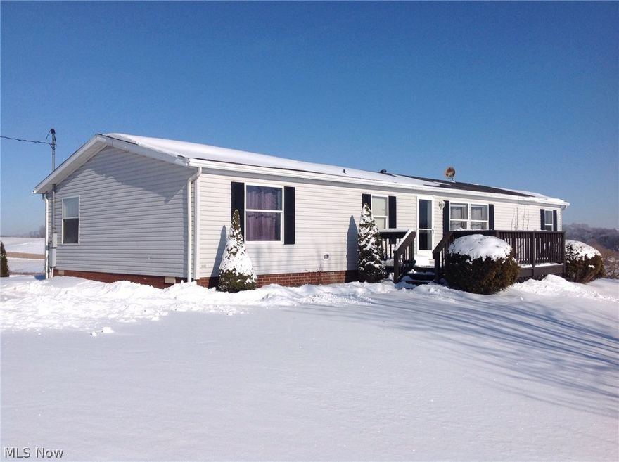 Welcome to 16415 Crowl St. SE! Beautiful and peaceful! If you seek privacy & serenity, this home is for you! What a majestic view from 5.16 acres sitting on top of a hill! Conveniently located minutes from Minerva and Great Trail Golf Course. This home was newly updated with all new flooring, large remodeled master bath with garden tub & separate shower unit. The interior has been freshly painted.  Garage is 2+ with recently cemented floor, and offers a lot of built in shelving for storage, closet space, exercise room, & office.  A wood burning stove makes it very cozy in the great room.  An HSA Home Warranty is included.