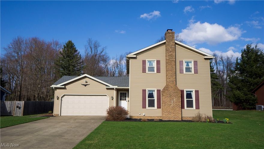 Amazing opportunity in desirable Rivermoor Estates allotment in Suffield Twp. Set on a beautiful lot with an enormous backyard, this 1,706 sq. ft. colonial floor plan with 3 bedrooms and 3 baths has tons of rustic charm. Recently updated vinyl siding, shutters and roof along with a timeless brick chimney create wonderful curb appeal. A lush front yard welcomes you to enter the home via the covered front porch. As you stand in the entry, you are flanked by a sizeable living room, stairway access to the sleeping quarters, and a doorway to the 2-car attached garage. You will also notice how the Oak trim creates a warm quality throughout the home. Conveniently located off the entry are a guest bath along with main floor laundry room with utility tub. The laundry room also offers access to the deck out back.  A fully equipped kitchen with a plethora of oak cabinets, and a peninsula with breakfast bar are adjacent to an ample dining space. The stainless-steel sink is positioned cleverly to provide views of the backyard. The living room sits at the front of the house and provides lovely views of the front yard. An aptly designed woodburning fireplace has a brick hearth and surround with wooden mantle. Upstairs, a massive master bedroom with vaulted ceiling anchors the sleeping area. A convenient ensuite bathroom sports a single vanity and shower stall. Two additional comfortably sized bedrooms and a full bath with single vanity, shower tub combo, and skylight round out the upstairs. Downstairs, a partially finished basement has three separate paneled and carpeted spaces serving as a recreation room, additional bedroom and an office. Outside, a generous wooden deck is great for outdoor entertaining or just relaxing and enjoying your beautiful backyard. A brick path/patio accents attractive landscaping while a wooden shed is the perfect place to store your lawn and gardening tools. Updates: Roof – ’19, Vinyl Siding – ’19, ‘Airtite’ Windows – ’07, Hot Water Tank – ’06.