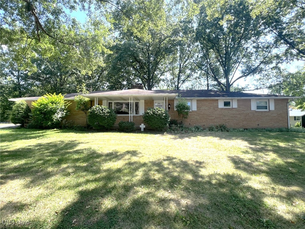 Looking for space and one floor living? Here it is! This 4 bedroom(all on main level), 3 bath all brick ranch offers nearly 3000 square feet of living space! That is not a typo! Add in another 500+ square foot, amazing 3 season room on top of that! This quality built home offers a main suite with 2 closets and full bath, additional full bath on main level with dual sinks, an enormous living room, cozy family room with fireplace, applianced kitchen with built in seating areas, and that amazing sun room! The full lower level offers another family room with fireplace, huge laundry and 2nd kitchen area, tons of storage, and walk up access to garage. Enjoy the park-like setting resting on nearly 3/4 acres and oh by the way there is a 22x20 detached workshop with heating and electric perfect for any hobby! Ideal location to shopping, highway etc. Updates include windows, central air, and high efficiency furnace! All of this for under 300k! Make this one yours!