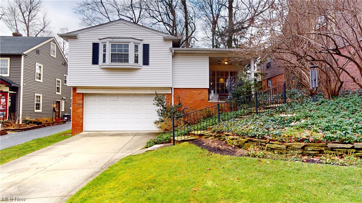 Welcome to this WELL maintained mid century modern Cleveland Heights split level!!! Open floor plan with all hardwood floors redone! Great for entertaining in your large open living room with beautiful beamed ceilings, built-ins and eat in kitchen. Family room with wood burning fireplace, half bath and attached two car garage. Has walk-out to back porch and fenced in backed yard. Has unfinished basement with lots of storage space. Second floor holds three large bedrooms all with large closets and two full bathrooms! Master bedroom has double closets with bay window and full master bath. Great location for shopping and restaurants with schools and parks near-by. Minutes from Main Campus and downtown.
