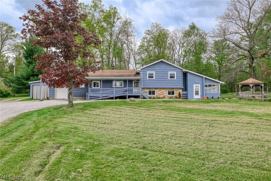Conveniently located close to town while still offering the feel of a peaceful country setting, this large and versatile home sits on 7.3 private, wooded acres and includes multiple outbuilding providing privacy, flexibility, and a rare amount of usable space. The home offers approximately 1500 sq ft of finished above-grade living space, plus an additional 900 sq ft of finished lower-level living area, for a total of over 2,300 sq ft of finished living space. There is also approximately 558 sq ft of unfinished basement space, ideal for storage or future expansion. The lower-level living area features large windows and a bright, open feel, as it is not fully below grade. The main living level features a functional layout with a spacious living room, dining area, eat-in kitchen, and a bright sunroom that adds natural light and extra living space. A bedroom and full bath on this level provide convenience and flexibility. The upper level includes a primary bedroom, two additional bedrooms, and a full bath, creating a comfortable and private sleeping area. The finished lower-level living area, with its own private entrance, includes a kitchen, family room, sitting room, laundry, and full bath. This space may be used as an in-law suite or as additional living space, perfect for guests, recreation, home office use, or extended entertaining. It's a must see with multiple ways of egress. Outside, the 7.3 wooded acres offer privacy and a scenic setting while remaining easily accessible to town amenities. Multiple outbuildings provide excellent storage, workshop, or hobby options. Don’t miss this unique opportunity to own a large home with flexible living space, private acreage, and the convenience of being close to town.