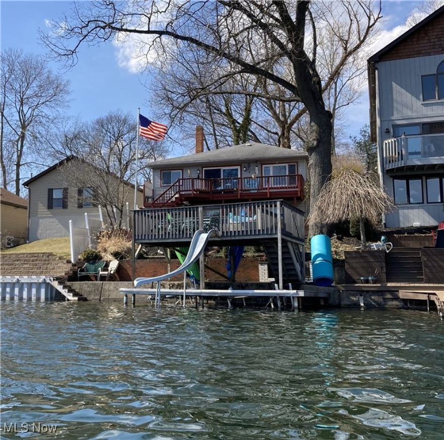 "Portage Lakes Waterfront Ranch" on *Portage Lakes Main Chain w/ access to all the beauty & joy that Portage Lakes offers, you can Boat to Lakefront Hot Spots, Ski, Fish, Canoe, Swim & More* 3 Bedroom Ranch w/ 2 Kitchens and a Lower Walk-Out Level to the Boat Dock + it's 2nd Level Lakeside Sun Deck w/ Slide! This Portage Lakes Home has been Loved/Owned by the same family for 50+ years & Never Been On Market Before, Truly a rare find nowadays! A Charming Lakefront Ranch on West Reservoir, simply add Your Personal TLC & updates to make it Shine! Enjoy the Lakefront View outside your window(s) & slider(s) of "Portage Lakes Main Chain" and Feel like you're on Vacation every day. *Jet-Ski Lift @ Dock & Misc. items Do Not Stay*