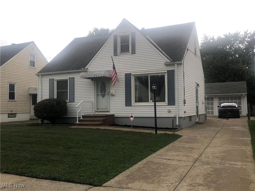 Don't miss this charming three bedroom 1.5 bath Garfield Heights Cape Cod! Absolute move-in condition! Eat in kitchen with new appliances (refrigerator, stove, and dishwasher), New flooring, and sliding glass doors leading to a small covered deck and patio. First floor has newly remodeled main bath and hardwood floors in living room and bedrooms. Upper level master bedroom has new carpeting, built-in dressers, and a half bath. Lower level has finished rec room, shower, glass block windows, and a second kitchen. Newer furnace installed in 2008 with central air. Some newer vinyl windows throughout. Full fenced in yard, Concrete drive, and a detached two car garage. POS violation free! One year home warranty included.