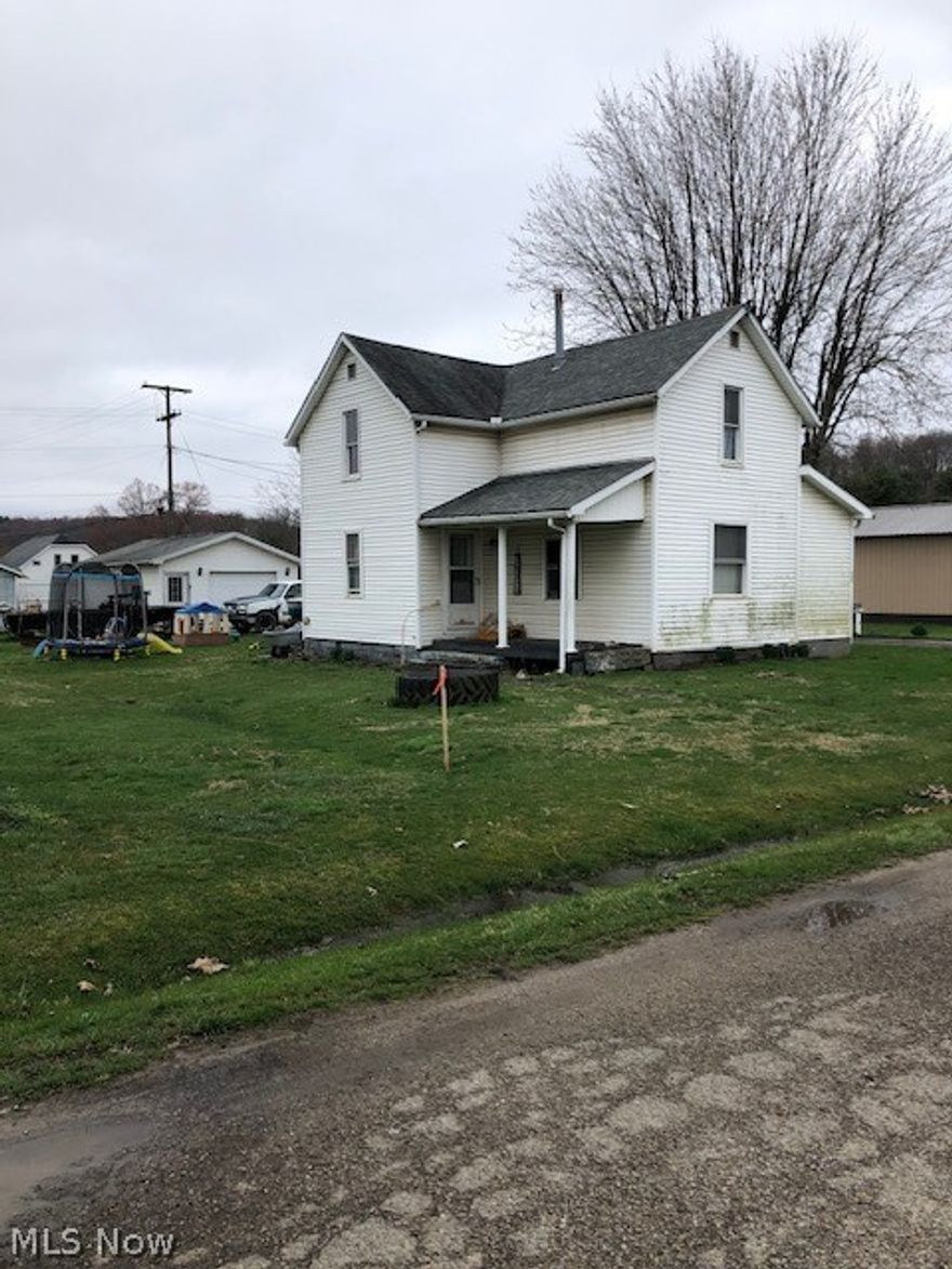 Close to town, this 3BR is situated on a nice level lot, with a spacious garage with a concrete drive. This home needs a little love and would make a good home.