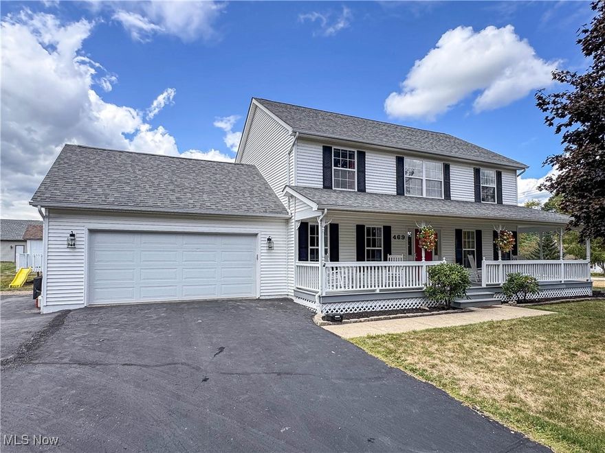 Gorgeous two-story, four-bedroom home with a wraparound porch in the Cimarron Development of Columbiana. The first floor offers a family room, dining room, half bath, and a flexible office that can also serve as a living room or first-floor bedroom, all with beautiful hardwood floors. The kitchen is a standout with granite countertops, island seating, oversized pantry, and all stainless steel appliances included. Sliding doors off the kitchen open to a covered deck, patio, and backyard.  Upstairs, the master suite features a private bath with double vanity and walk-in closet, accompanied by three additional bedrooms and an updated full bath with tiled shower, new vanity, and modern lighting. Convenient second-floor laundry adds to the functionality. The full basement provides excellent potential for finishing and has a storage room with built-in shelving. The attached two-car garage has hot and cold water and gas hookup for a heater and stove. In addition, the property includes a 24x24 insulated garage/workshop with a mini-split HVAC system for year-round comfort, custom lighting, shiplap accent wall, and flexible use as a man cave, shop, or second kitchen. Smart features enhance both the home and garage, including exterior lighting, garage doors, and switches all on smart controls. An extra-large paved driveway, playset, storage shed, attractive landscaping, and desirable corner lot complete this impressive property.