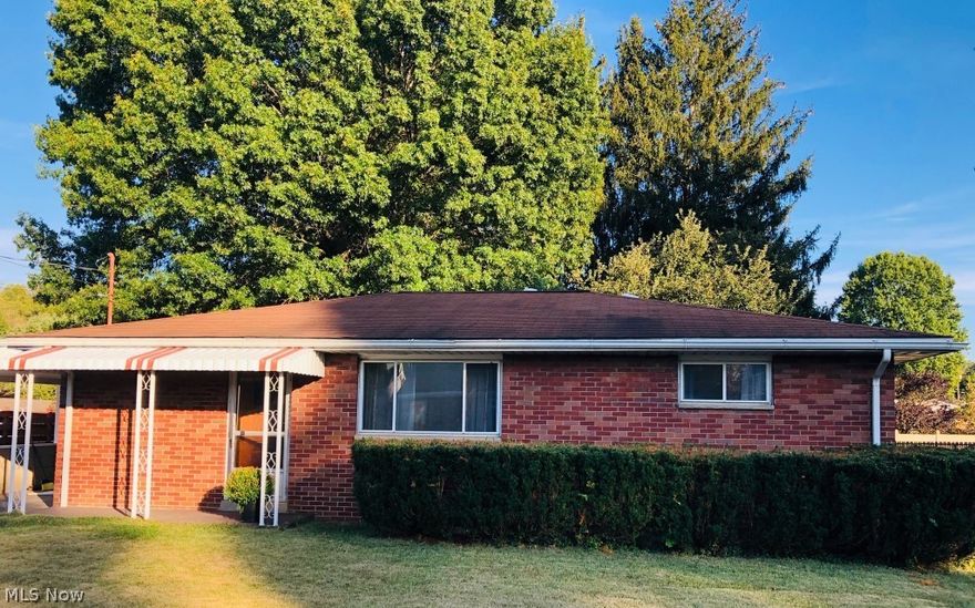 The interior of this home has been beautifully remodeled offering new kitchen with granite countertops and stainless steel appliances, open to dining room and living room all offering beautiful refinished hardwood floors, new bath with ceramic tile flooring, bedrooms all offer refinished hardwood floors.  Dining room exits to carport and patio with large flat, fenced in back yard and gas hook up fire pit.   Updates including electrical, brand new HVAC with new duct work, 2016 new hot water heater. Basement has a partially finished rec area and large laundry area with storage.