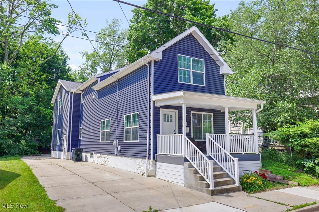 Amazing opportunity to own a spacious, newer construction home in vibrant West Akron! Originally rebuilt from the foundation up in 2019, this home features 2,011 sq ft above grade, offering exceptional space and modern amenities. The first floor welcomes you with a large open-concept kitchen and living area, plus a convenient half bath. Upstairs boasts 3 generously sized bedrooms, 2 full baths, and a second-floor laundry—no more basement laundry runs! The oversized primary suite includes a private full bath and large walk-in closet. Enjoy a 2-car attached garage at the rear, plus a concrete driveway spanning nearly the entire lot—providing ample parking and low-maintenance landscaping. The finished basement recreation room is perfect for a home theater, office, playroom, or 4th bedroom. This home also benefits from Akron's 15-year, 100% tax abatement—completed in 2019 with approx. 9 years remaining, offering major savings with property taxes under $650/year. A rare find: newer construction, size, close to highland square, and tax savings all at this price—schedule your showing today!
