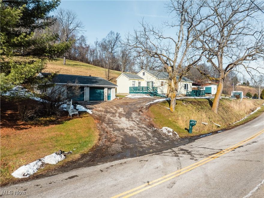 This 13.37-acre property offers a peaceful country setting with a mix of open ground and wooded acreage, providing privacy, scenic views, and room to explore. The 2-bedroom, 1½-bath home features a living room with a cozy fireplace, an eat-in kitchen, two main-level bedrooms, and a full bath. A walk-up attic provides additional space with the possibility of being finished out. The back deck offers a nice spot to enjoy the surrounding views and outdoor setting. The home includes a partial basement with crawl space and walk-out access. Mechanics include a propane furnace, wood burner, central air, private well and septic system (will need to be replaced.) Outbuildings add versatility to the property, including a 32×32 detached 2-car garage, a 15×20 block building suitable for storage, workshop space, or hobbies and a variety of other multi-use buildings. The surrounding acreage and rolling landscape create a quiet rural atmosphere with plenty of opportunity for recreation, gardening, or future improvements. All HBP mineral rights will transfer with the property.