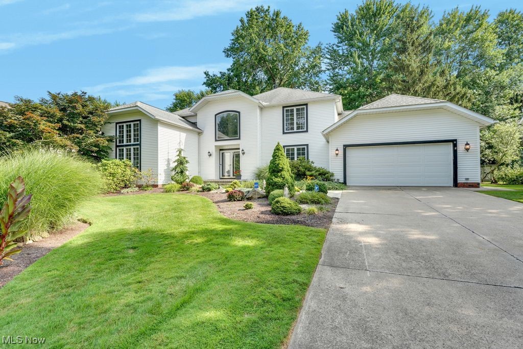 Welcome to this stately colonial offering over 3,500 square feet of beautifully updated living space, nestled on a picturesque, landscaped lot. A rare first-floor primary suite features an updated glamour bath with jetted tub, walk-in shower, double sinks, and a large walk-in closet. The light-filled main level includes a dramatic vaulted living room, a two-story family room with fireplace, and a formal dining room—perfect for entertaining. The spacious, fully updated kitchen boasts a center island with seating, newer cabinetry, appliances, and a generous eating area that opens to a stunning sunroom. Enjoy views of the private, tree-lined backyard complete with a stone patio and tranquil koi pond. Additional highlights include a first-floor laundry room, powder room, fresh paint, new fixtures, and newer wide-plank luxury vinyl flooring throughout much of the main level. Upstairs, you’ll find three generously sized bedrooms and a full bath. The finished lower level with fresh paint and carpet expands your living space with two large rec rooms, multiple storage areas, and a flexible bonus room ideal for a playroom, home gym, or hobby space. Furnace and A/C less than 2 years old. This move-in-ready home is full of natural light and offers a fresh, modern feel in an ultra-convenient location close to everything. A must-see!