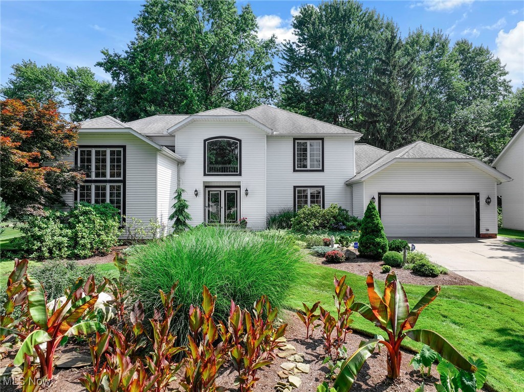 Welcome to this stately colonial offering over 3,500 square feet of beautifully updated living space, nestled on a picturesque, landscaped lot. A rare first-floor primary suite features an updated glamour bath with jetted tub, walk-in shower, double sinks, and a large walk-in closet. The light-filled main level includes a dramatic vaulted living room, a two-story family room with fireplace, and a formal dining room—perfect for entertaining. The spacious, fully updated kitchen boasts a center island with seating, newer cabinetry, appliances, and a generous eating area that opens to a stunning sunroom. Enjoy views of the private, tree-lined backyard complete with a stone patio and tranquil koi pond. Additional highlights include a first-floor laundry room, powder room, fresh paint, new fixtures, and newer wide-plank luxury vinyl flooring throughout much of the main level. Upstairs, you’ll find three generously sized bedrooms and a full bath. The finished lower level with fresh paint and carpet expands your living space with two large rec rooms, multiple storage areas, and a flexible bonus room ideal for a playroom, home gym, or hobby space. Furnace and A/C less than 2 years old. This move-in-ready home is full of natural light and offers a fresh, modern feel in an ultra-convenient location close to everything. A must-see!