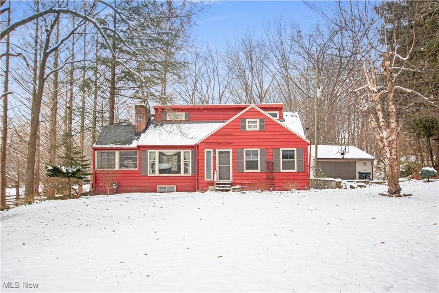Experience peaceful, wooded living just minutes from city amenities on this .581-acre property located near The Metroparks. This spacious home offers three finished levels with 4 bedrooms and a walk-out lower level that expands your everyday living space. The walk-out level features oak laminate flooring, the home’s kitchen, a family room with a wood-burning stove, a full bath, a utility room, and a large entry area that opens to a covered patio.

The main floor provides a bright living room, two bedrooms, a generous sitting area, and a fully enclosed all-season room perfect for relaxing throughout the year. Charming touches include a decorative fireplace and a beautifully restored Dutch door with spun-glass and leaded-glass accents.

The third floor offers two additional bedrooms and a half bath, ideal for extra sleeping space, an office, or creative use. Outdoors, enjoy entertaining and make use of the 2-car detached garage with redwood siding and a convenient turnaround area.