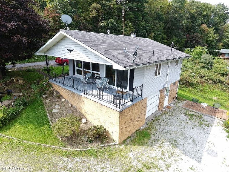 Amazing lake views from this 2 bedroom lake home on a .25 acre lot on private land (no lease). A huge covered porch will be loved by family and friends with these incredible lake views. The same views are enjoyed from the open format kitchen, dining area and living room through large beautiful windows. Docking rights for your nautical toy is available nearby for a nominal one time buy in fee. Also on the main floor are two bedrooms and 1 full bath. The kitchen includes the refrigerator and stove and offers a large pantry. In the basement is a one room which has the furnace, shower and washer and dryer hook ups, a one car heated garage and large spacious storage/ workshop area. Gently landscaped with ornamental fish pond and waterfalls. Only a mile from Marina East and just about 3 miles into Dellroy. This home is well suited for year round living or for that lake home you have always dreamed of.