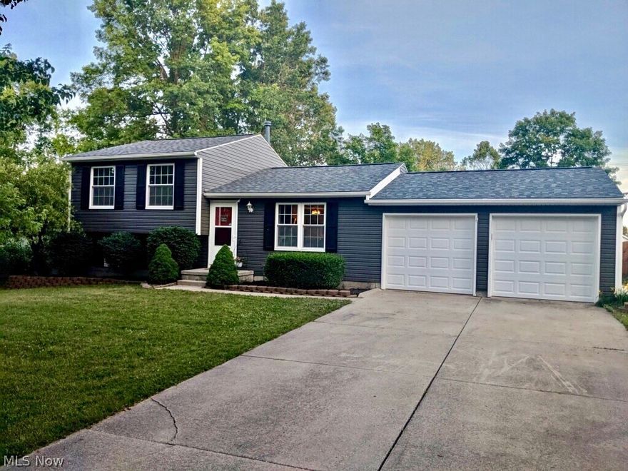 This 3 bedroom, 2 full bath Split Level in Stow is the home you've been waiting for!  You will be welcomed by the newer siding and roof as you pull into the paved driveway and 2 car attached garage.  The completely updated kitchen has refinished cabinets, backsplash, matte finish granite countertops, and new appliances. French doors open from the kitchen to a large screened porch & patio for relaxing and entertaining.  The stair cases are custom pallet wood. Bruce hardwood floors on the main level flow from the living room into the kitchen.  A large Barn door decorates the family room as well as serving as a divider between the two levels.  The custom framed television was made for the Media Room and play room. Enjoy the extra space of the finished basement, with laminate flooring. Shelving has been added in the basement and garage for extra storage.  Schedule your appointment to see this move in condition, freshly painted, neighborhood home today.