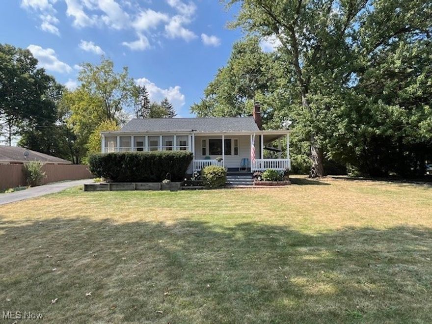 Well-maintained 2 BD, 2BA Ranch situated on a .28-acre lot. Cozy up to the fireplace in the living room and enjoy beautiful views from the huge picture window overlooking the deep front yard. Kitchen has some newer pullout shelves and newer vinyl plank flooring. The lower level features a great family room w/additional fireplace, bar, a second full bath and storage room. Second bedroom boasts a cedar closet. Relax on the enclosed 20x18 porch w/storm windows and an open 22x8  wrap-around front porch. Updates include newer replacement windows (15 yrs), hot water tank (3 yrs), new roof on house (2024). One car garage and carport. Fenced rear yard.