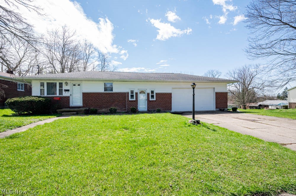 So Much Living Space In This Ranch Home.. it Will Fool You From The Outside! Enter through your choice of two doors: One into a Mud room with a door that opens to the Spacious 2 car Heated garage. The other to a welcoming, freshly painted living room adorned with new vinyl flooring and showcased with plenty of Natural Sunlight. Open concept Kitchen and Dining Room with sliding glass doors that lead to a Large, Beautiful, enclosed 4 season Sun Room that overlooks a sizeable back yard. These large areas make entertaining and family gatherings Easy! Finishing off the first floor is 3 Bedrooms (one includes laundry hook ups if needed) 2 really nice sized ones that are joined by a full bathroom and a guest/main Bathroom. The Entertaining space continues on the lower level with a large finished basement. This space includes a bar area, a cozy electric Fireplace and a full bathroom. Updates include Newer Roof, Furnace, Water Heater and Gas Heating in Back sun room and Windows.