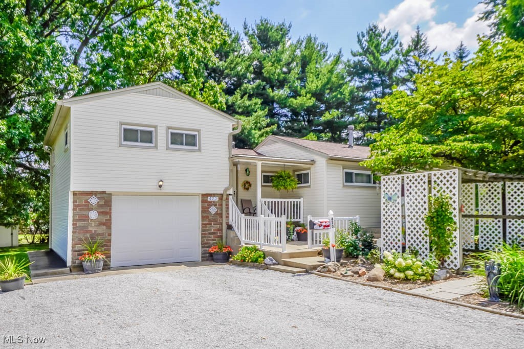 Amazing find in Perry Township! This beautifully maintained 4 bedroom home sits on 3/4 of an acre and offers inviting spaces inside and out. The living room features a knotty pine paneled accent wall, while the updated kitchen shines with stone countertops, ample cabinet storage, and all appliances, opening to the dining area. Two bedrooms and a full bath are on the main level, with two more bedrooms and a half bath upstairs. The full waterproofed basement includes a summer kitchen, rec room area, laundry, and walk out access to a patio and backyard with a fire pit and shed. A pergola covered patio at the front of the home sits alongside the driveway to the one car attached garage. Well cared for with a newer boiler, hot water tank, Windy Hill Hardwoods remodeled kitchen, and updated windows and siding. Located on a quiet dead end street in Perry LSD, close to shopping and dining. Call today to schedule a tour!