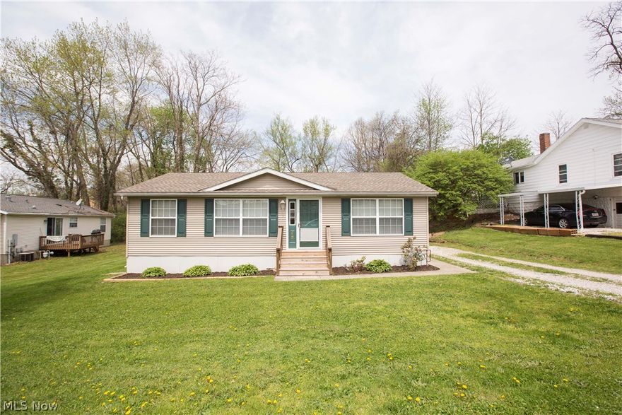 Gorgeous Lake living!  Beautiful open floor plan!  Cathedral ceilings, sky lights, and large windows throughout!  First floor living with lake views from the front yard!  3 bedroom, 2 full bath ranch home 1 block from the Lake!  Expansive foyer welcomes you into the great room with picture windows and cathedral ceilings.  Newly remodeled kitchen has massive amount of cabinet and counter space and boasts new appliances and countertops.  Beautiful sliders lead you onto a deck for outdoor entertaining area!  Unbelievable amount of storage space throughout!  Large first floor laundry room with additional cabinets and storage.  3 large oversized bedrooms all with walk in closets!  Master en suite is its own retreat with private bath that boasts walk in shower and additional soaking tub!  Many updates that include roof, sky lights, well, flooring, and tank-less water heater just to name a few!  Minutes from expressways, restaurants, shopping, all of Portage Lakes amenities, however tucked aw