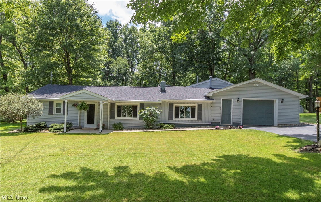 Large Lake Milton ranch with Lake Access and Eligibility for Dock Rights. This home sits on 100x220 lot that boarders park-like setting state property with 16x23 back patio, partial privacy fence, & 8x10 storage shed. Inside the home is 3 beds and 2 full baths. Large living room with plenty of natural light throughout from picture window & large dining room with built-in shelves. Open, updated kitchen with eating area & appliances stay. Large master suite has an attached living room, could be a family room with gas fireplace, gas logs and park-like view. Master suite also includes higher ceilings, bathroom with walk-in shower, whirlpool tub, and doorway to rear patio. Attached garage. Many updates including 2 furnaces & central air (2005 & 2008), Roof new 2018, siding & windows 2003, hot water tank 2008, new paint throughout, gutter guards, security system. Call Today!