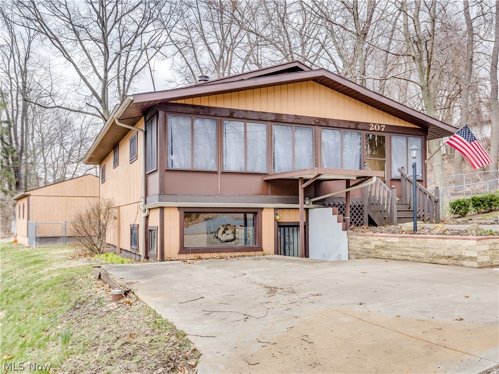Enjoy ranch style living with a short walk to the water. This one is an outdoor lovers dream with plenty of nooks and porches to enjoy. The enclosed front porch provides plenty of sunshine. Arrive through the front door to a spacious open floor plan with a fireplace, built in shelving and plenty of room to spread out. The dining area/kitchen has patio doors leading to the fenced in side yard. The walk out basement hosts the other two bedrooms and a separate entrance. The lower level second bath is connected to one of the bedrooms and leads to the laundry and utility area. Lots of flexibility in this one. Ideal set up for extended family living or even a rental suite. Extra parking pad in front, or turn on Falcon and park by the garage and alley. Windows 2013. Furnace 2005. AC 2012. Well has been chlorinated and checked in 2017.