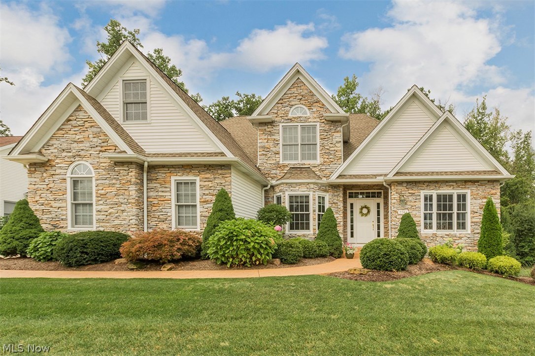 Stunning colonial located on a private wood lot. This home features a large eat-in kitchen with granite countertops, double ovens, hardwood floors and leads out into sun-filled 4 season room. Your elegant dining room has a beautiful tray ceiling, corner built-in shelves, plantation shutters and chair molding. The two-story great room has floor-to-ceiling built-ins, beamed ceiling, a fireplace with a walk-out to the large deck. The cozy den on the first floor is great for an office or extra living space with built-in bookshelves. The first floor master suite includes a large bedroom with vaulted ceiling, walk in closet with newer closet system, spacious master bathroom with double sinks, soaking tub and large shower. Make your way to the second floor with features two additional bedrooms, full bath and an office that can be used as a 4th bedroom. The lower level is not to be missed! It features a huge rec room with wet bar and wine cellar. There is also a full bath and bedroom area, gre