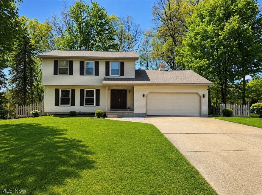 Imagine stepping home to this beautifully updated and meticulously maintained Canfield colonial. The welcoming foyer opens to a bright, spacious living room that flows into the formal dining room, ideal for daily living and entertaining. The updated kitchen features a new island, cabinets, countertops, stove, microwave, hood, and ceramic tile flooring. A refreshed first-floor powder room includes a new vanity, light-up mirror, toilet, sprayer, and new doors across the main level, with new flooring enhancing its move-in-ready feel. The oversized family room offers a cozy space with a wood-burning fireplace and sliding doors to the back deck, overlooking a peaceful, park-like backyard. The finished basement adds significant living space with new drywall, flooring, a full bathroom with a shower, bar, gym, kids’ room, workshop, and laundry room. The attached two-car garage provides attic storage and easy kitchen access. Upstairs, three spacious bedrooms with ample closets feature updated full bathrooms with standing showers, new tiles, vanities, mirrors, toilets, sprayers, and new windows. The recent upgrades including a new roof (2015), vinyl siding (2015), furnace (2019), central air (2020), electrical panel (2022), new 7 windows in (2024), water tank (2011), and interior updates like new flooring, fixtures, and porch columns. Fully updated throughout, it offers comfort and modern convenience, ready to move in. Located just 3 minutes from CH Campbell, 8 minutes from Canfield Middle School, and near the Mill Creek bike path, in a desirable neighborhood, this home checks all the boxes.