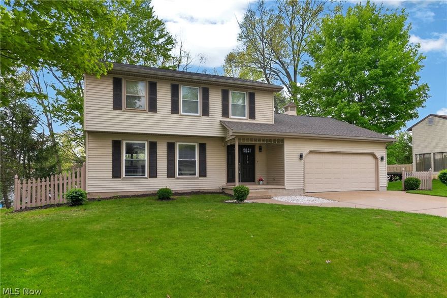 Imagine stepping home to this beautifully updated and meticulously maintained Canfield colonial. The welcoming foyer opens to a bright, spacious living room that flows into the formal dining room, ideal for daily living and entertaining. The updated kitchen features a new island, cabinets, countertops, stove, microwave, hood, and ceramic tile flooring. A refreshed first-floor powder room includes a new vanity, light-up mirror, toilet, sprayer, and new doors across the main level, with new flooring enhancing its move-in-ready feel. The oversized family room offers a cozy space with a wood-burning fireplace and sliding doors to the back deck, overlooking a peaceful, park-like backyard. The finished basement adds significant living space with new drywall, flooring, a full bathroom with a shower, bar, gym, kids’ room, workshop, and laundry room. The attached two-car garage provides attic storage and easy kitchen access. Upstairs, three spacious bedrooms with ample closets feature updated full bathrooms with standing showers, new tiles, vanities, mirrors, toilets, sprayers, and new windows. The recent upgrades including a new roof (2015), vinyl siding (2015), furnace (2019), central air (2020), electrical panel (2022), new 7 windows in (2024), water tank (2011), and interior updates like new flooring, fixtures, and porch columns. Fully updated throughout, it offers comfort and modern convenience, ready to move in. Located just 3 minutes from CH Campbell, 8 minutes from Canfield Middle School, and near the Mill Creek bike path, in a desirable neighborhood, this home checks all the boxes.
