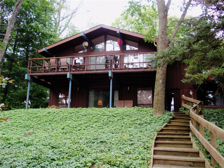 WOW!! Will you be the lucky one to be able to vacation at home all year around? The awesome contemporary raised ranch home sits on 1.49 very private wooded acres. This home is a rare opportunity to own a lake front home on East Twin Lakes with a "40ft. Trex maintenance free" dock in your backyard. Swim, fish, boat and enjoy the gorgeous sunset views from your living room deck , and patio through all four seasons. The main level offers a huge living room with brick fireplace, full wall of sliding doors opens to the deck. The kitchen has ample counter and cabinet space for easy meal preparations. The formal dining room adjoins the kitchen and living room for entertaining your dinner guests. The master bedroom has one wall of closet and drawer space that will surprise  you and full bath with shower and large vanity. There is a half bath off the foyer on this level as well. The wood floors on this level are beautiful. Moving to the lower level you will find another huge family/great room w