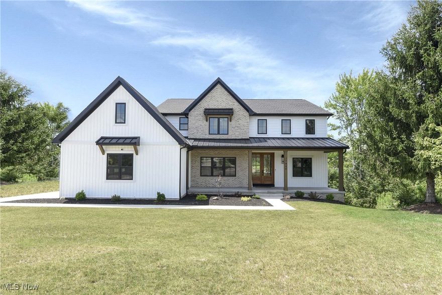 Prepared to be moved! Welcome to 17440 Sawgrass Circle, North Royalton, OH 44133 — a stunning two-story colonial built in 2024 that blends modern luxury with timeless charm. Step inside the spacious foyer where on either side of the entryway are two large, flexible spaces: one designed as a private home office, ideal for remote work or study, and the other a bright, inviting room perfect for family gatherings or entertaining guests. Continuing through the home, you'll enter the expansive living room featuring vaulted ceilings, a striking fireplace as the focal point, and built-in shelving that adds both style and functionality. This space flows effortlessly into the state-of-the-art kitchen, outfitted with sleek modern cabinetry, stainless steel appliances including built-in ovens, and a generous walk-in pantry. The main floor features a private bedroom with its own full bathroom — perfect for guests or multigenerational living — as well as an additional shared full bathroom for added convenience. A custom-built mudroom is located just off the three-car attached garage, providing both function and organization. Upstairs, the spacious master suite includes a luxurious full bathroom, creating a private retreat. You'll also find two additional bedrooms, a loft area ideal for a playroom or media space, and another beautifully appointed full bathroom. The finished basement expands your living space with two more bedrooms, a full bathroom, and walk-out access — perfect for guests, in-laws, or a secluded retreat. Outside, enjoy the large deck — an ideal spot for summer gatherings or simply relaxing in the fresh air. The three-car garage offers ample room for vehicles and additional storage. Ideally located with easy access to several golf courses and just minutes from I-80 and I-3, this home offers a perfect balance of peaceful living and commuter convenience. Experience refined living where every detail has been crafted for a life well-lived. Schedule your tour today!